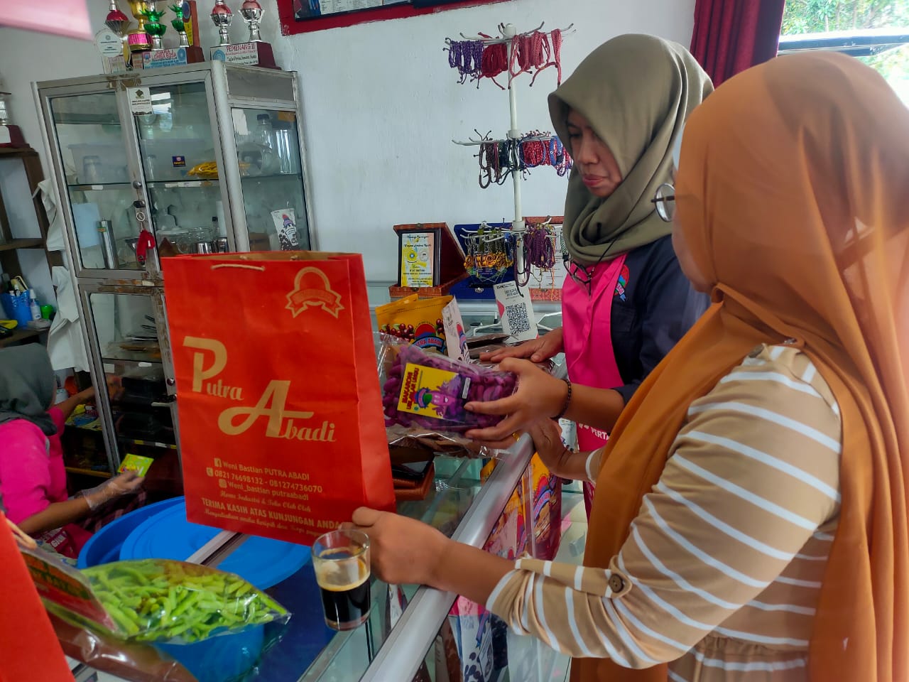 Wenny, owner UMKM Putra Abadi saat sedang melayani pelanggannya di tokonya di Kota Pagar Alam Sumsel  (Indodaily.co / Nefri Inge)