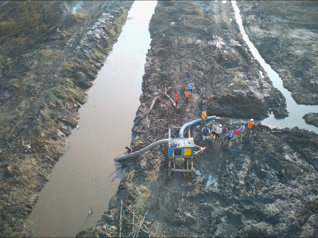 Sistem pembasahan lahan gambut, air diambil dari kanal atau sumber air lainnya, kemudian dipompakan ke dalam lahan gambut yg telah digali menggunakan excavator dibuat menjadi embung, sehingga air masuk ke gambut (Dok. Humas BNPB)